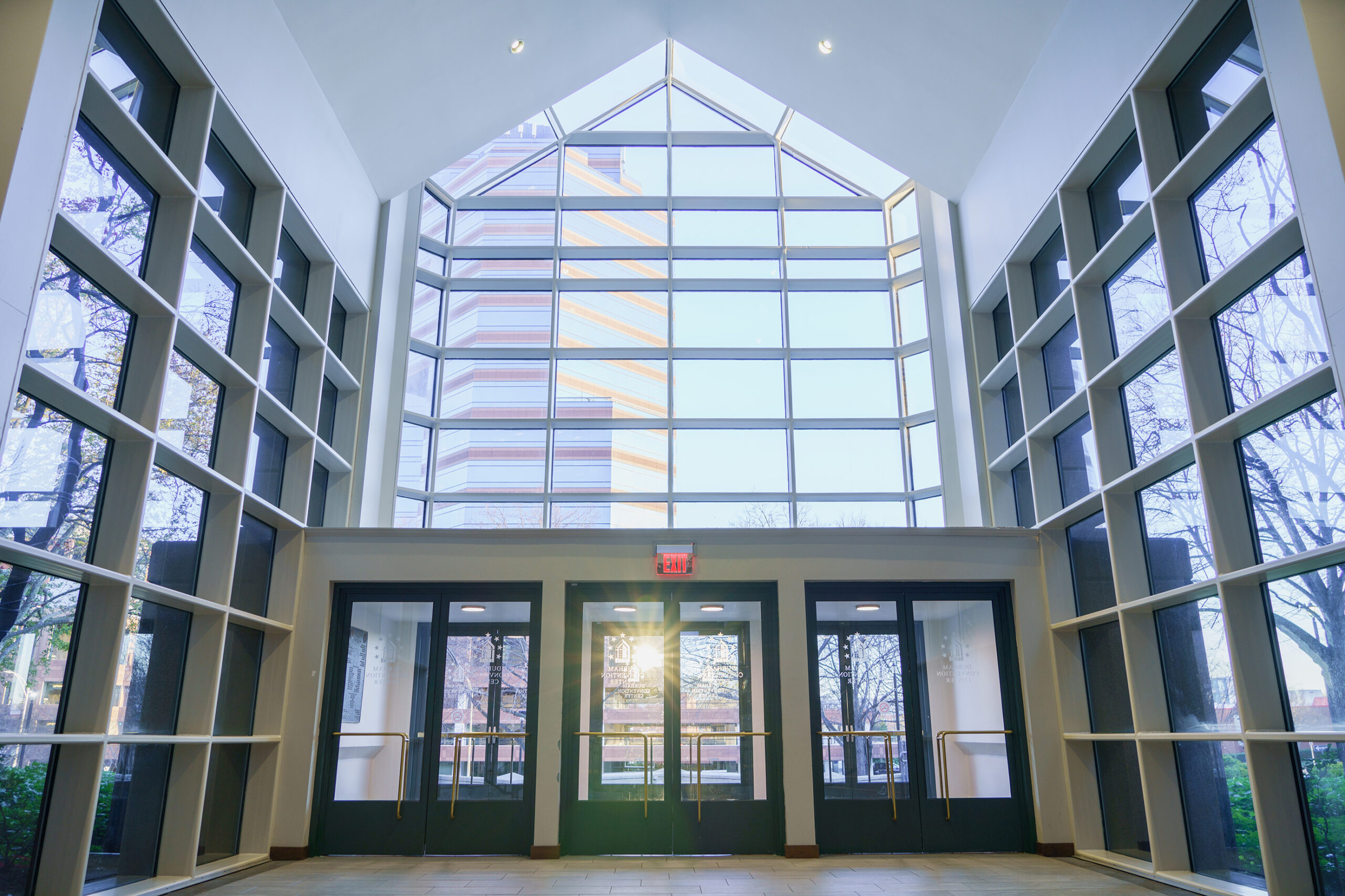 Interior photo looking through the glass windows at Durham Convention Center lobby entrance