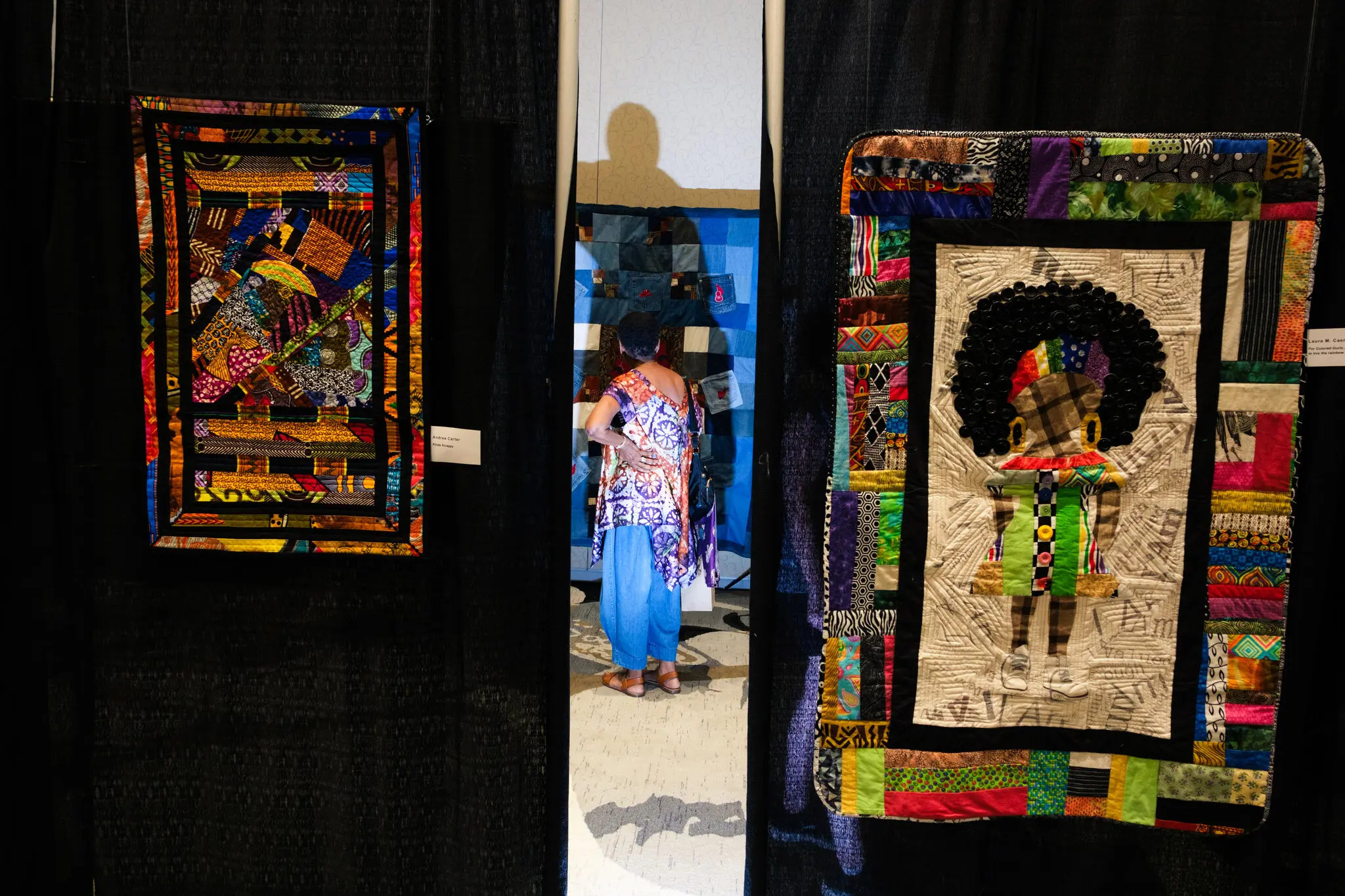 Photo of quilts hanging at the Durham Convention Center in North Carolina during a quilting convention.